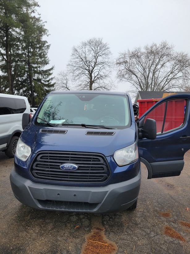 Cargo van with driver door open, staged for a dash camera install