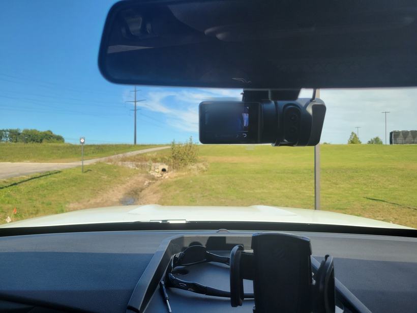 Installed dash camera showing a live camera feed on its screen during verification