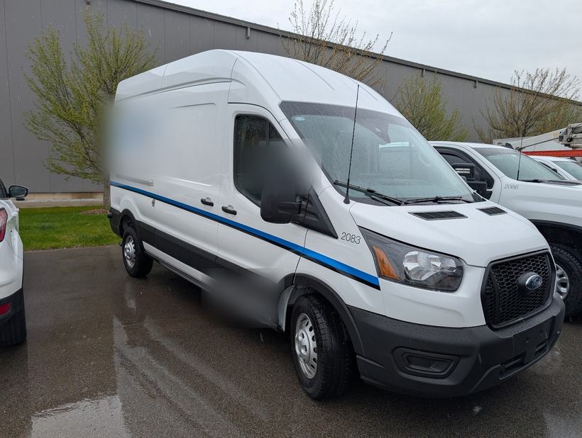 High-roof cargo van staged at a fleet yard before a telematics install