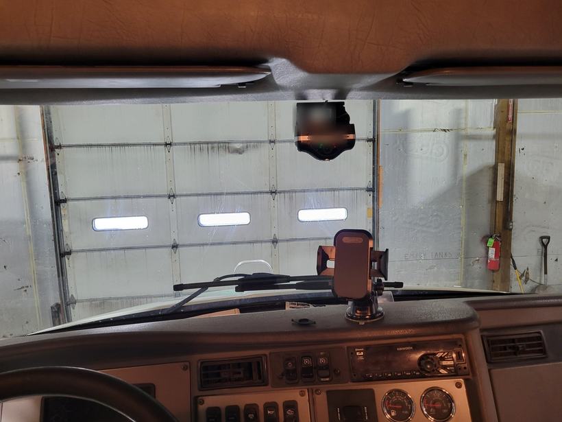 Dual-facing safety camera mounted at the headliner of a semi tractor cab